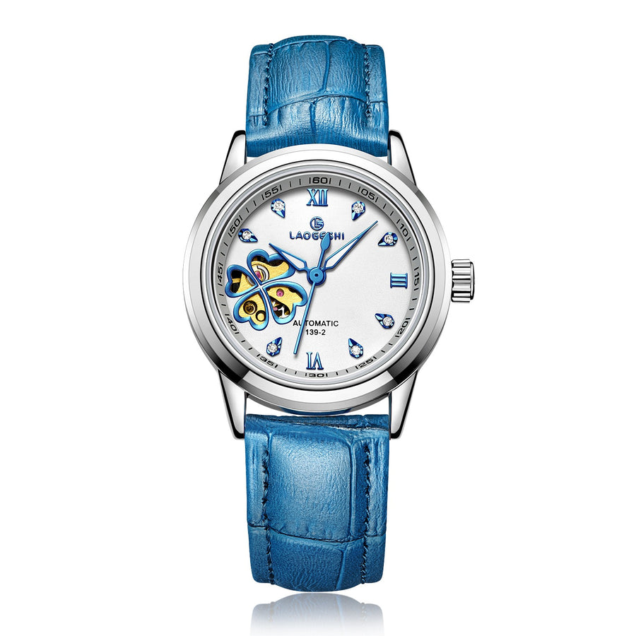 Silver automatic watch, white dial with blue four-leaf clover skeleton cutout, blue leather strap