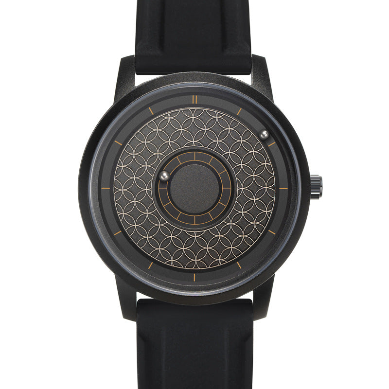 Black quartz watch with a magnetic ball bearing dial worn on a wrist with a metal bracelet