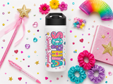 White water bottle with a black lid, printed with the name Sophia in tall rainbow bubble letters filled with hearts and stars, with the words Sparkle Squad beside it in pink script.